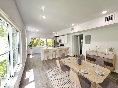 a dining room and kitchen with a table and chairs
